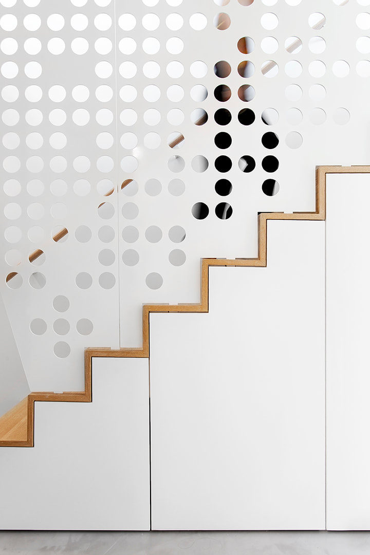 profile of stairs with perforated screen in vancouver condo by haeccity studio architecture, krista jahnke photography