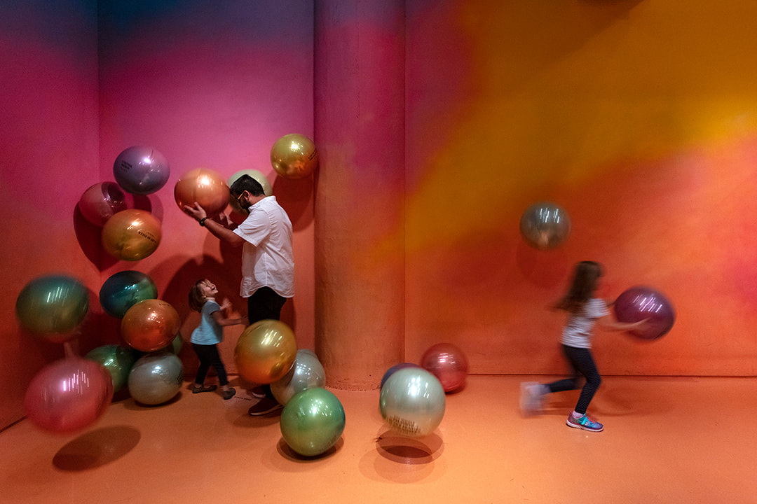 kids playing with floating balls at the color factory nyc