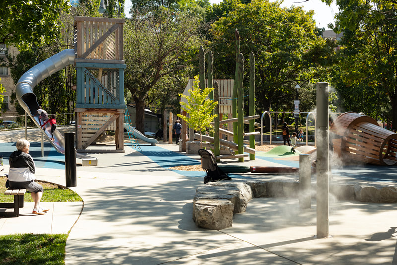 kids with parents at st. james park playground by pma landscape architects in toronto, ontario